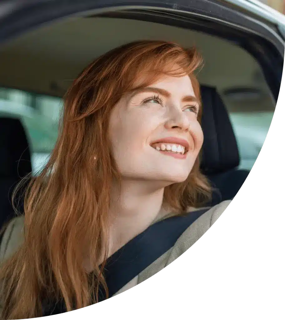 Smiling Woman Looking out of her Car Window